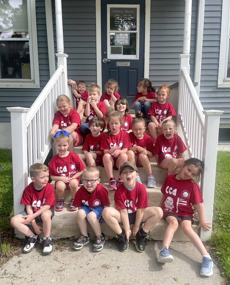 Kindergarten students from Caryl E. Adams Primary School on the steps of the Mary Wilcox Memorial Library.