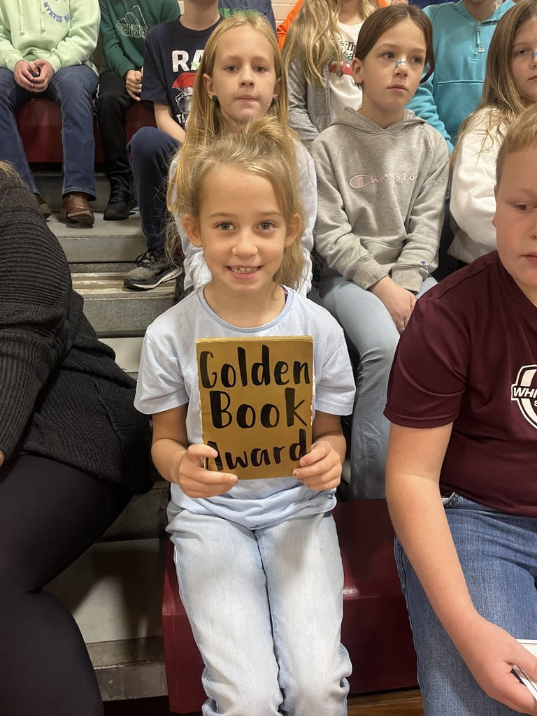 student with golden book award