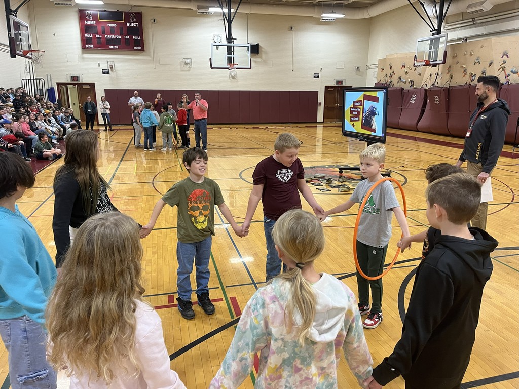 group of students in a circle with a hula hoop