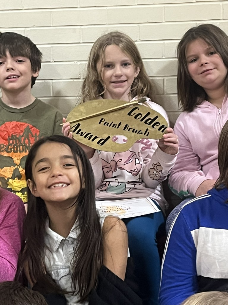 student with golden paint brush award