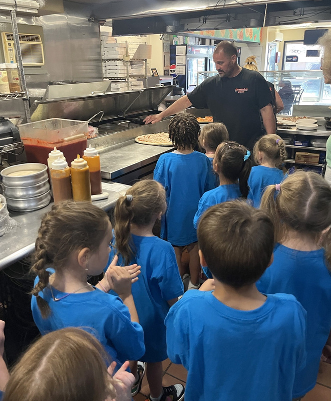 C E A  Kindergarten students in the kitchen at Dominics get a lesson on how pizzas are made.