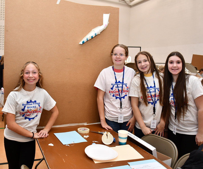 Another team of four students from T R A in grades 6 though 8 stand by the rudimentary machine they are beginning to build for Middle School Engineering Day at Broome Tioga BOCES.