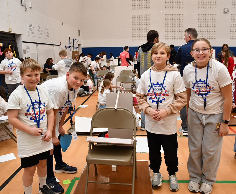 Four Tioughnioga Riverside Academy students competing in the Elementary Engineering Day competition stand by their design as it is in mid-construction.