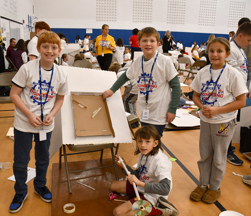 Four more T R A students on a different team with the beginning of their Rube Goldberg machine.