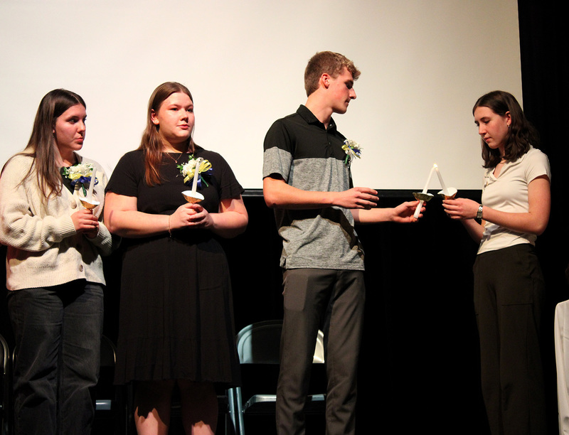 The Whitney Point High School Honor Society secretary lights the candle of the first inductee at the beginning of the Induction ceremony on December 4, 2025.