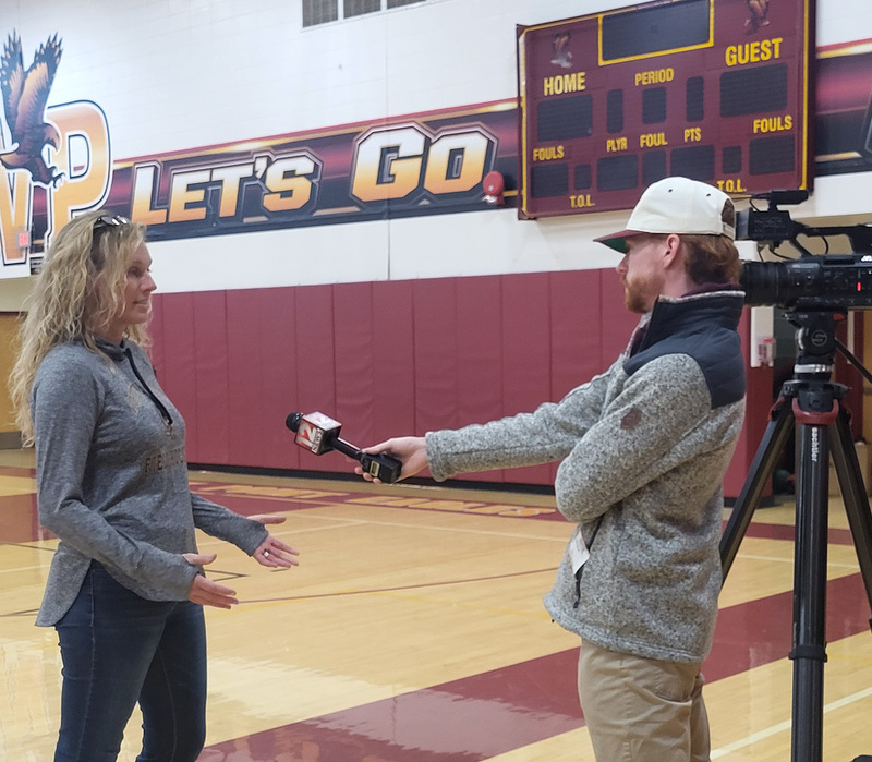 Whitney Point High School Varsity Field Hockey Coach Nicole Huston being interviewed by WBNG-TV Sports Director Kyle Spisak in the high school gym.