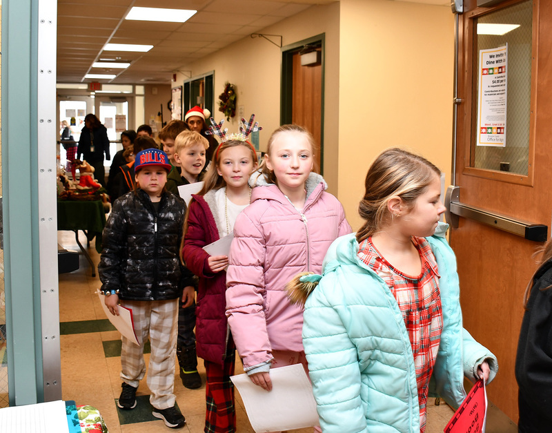Fourth graders from Tioughnioga Riverside Academy file into the Northern Broome Senior Center on December 15, 2025, prepared to share some holiday spirit.