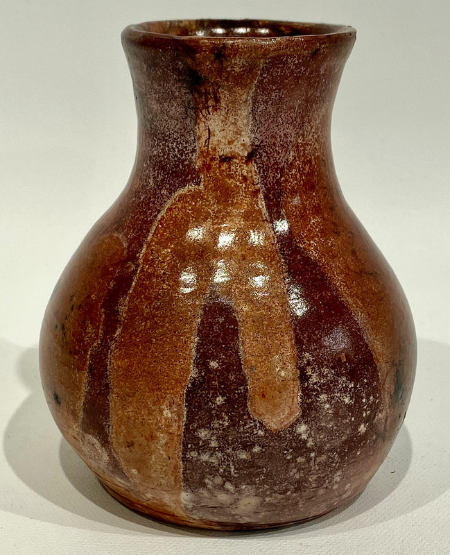 Another ceramic pot created by a student fired with lighter and darker brown variations.