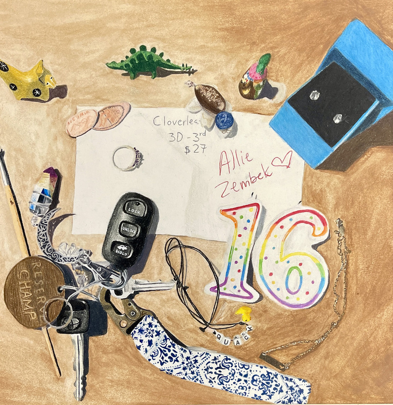 A tableau of meaningful objects lay scattered on the sand of a beach. They include a toy dinosaur, a set of car keys, a 16th birthday candle, a silver ring, a stone turtle and a set of diamond earrings in a jewelers box.