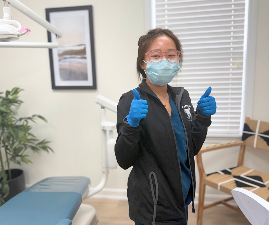 Dental Assisting student An Ngo gives 2 thumbs up at her co-op job.