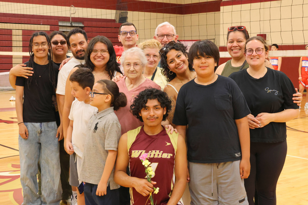 Nate Gutierrez, a senior volleyball player smiling with his family.