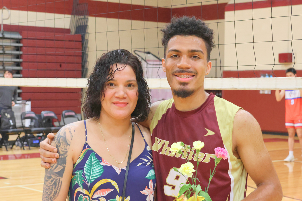 Leonidas Flores, a senior volleyball player smiling with his mother.