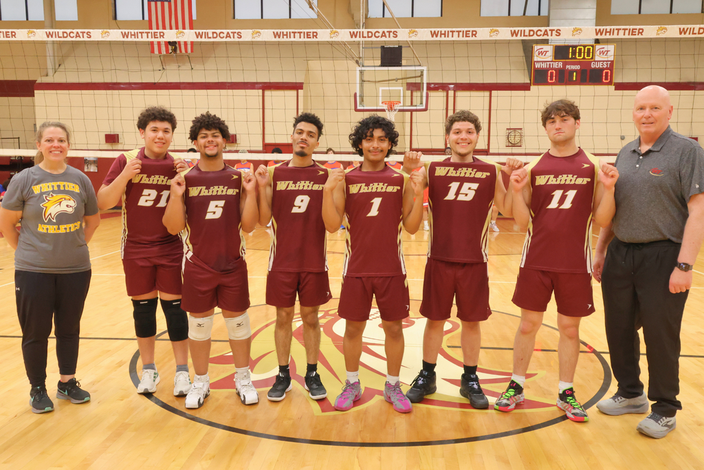Whittier Tech Senior Boys Volleyball Players showing off their jerseys with their Coaches.