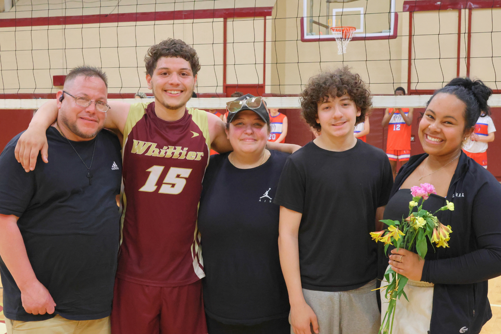 Miguel Robles, a senior volleyball player smiling with his family, and the Team Manager, senior Sanaa Guzman.