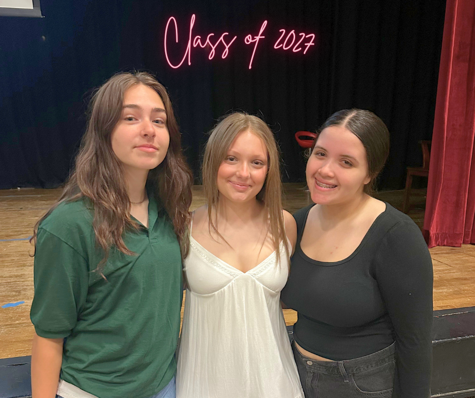 Three students in the Class of 2029 standing in the auditorium after presenting their candidate speeches for Student Government.