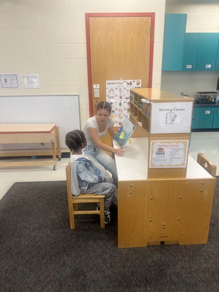 Student helping child read