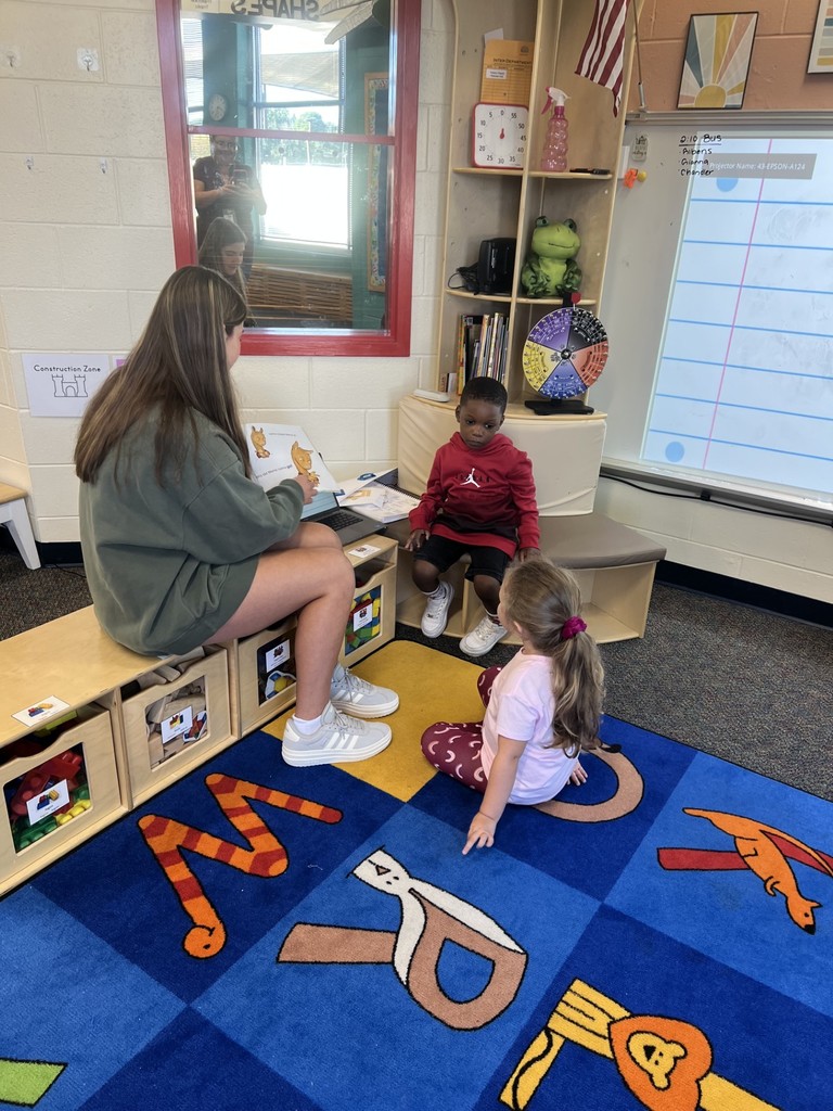 Student helping child read