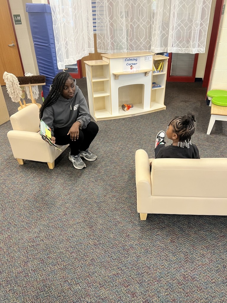 Student helping child read