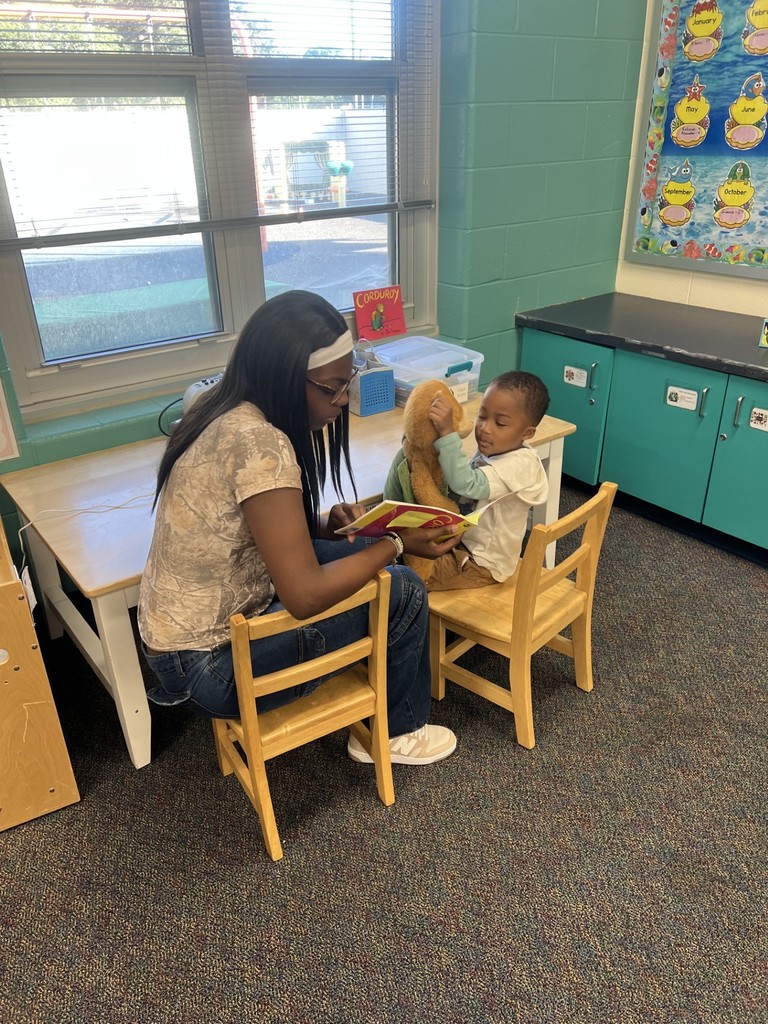 Student helping child read