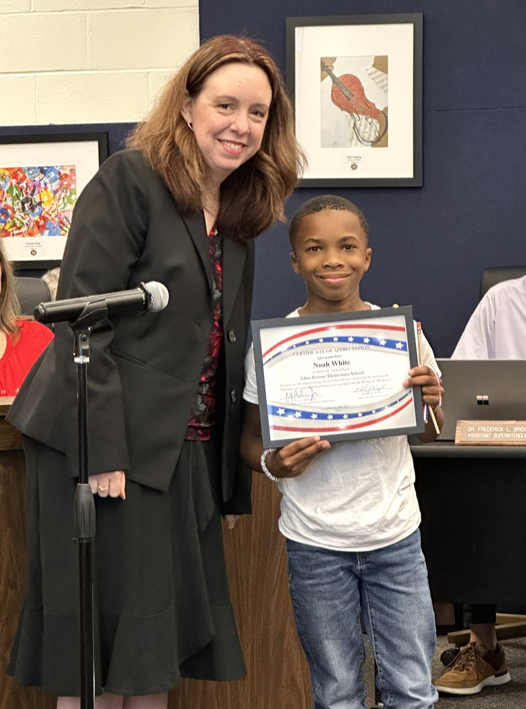 Studentreceives certificate for leading Pledge of Allegiance at Board of Ed meeting