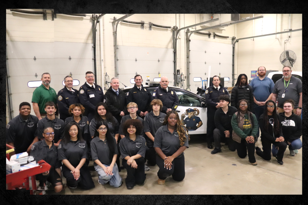 Image of CTE Criminal Justice and Collision Repair students and faculty along with members of the Salisbury Police Department which donated a police cruiser to the program