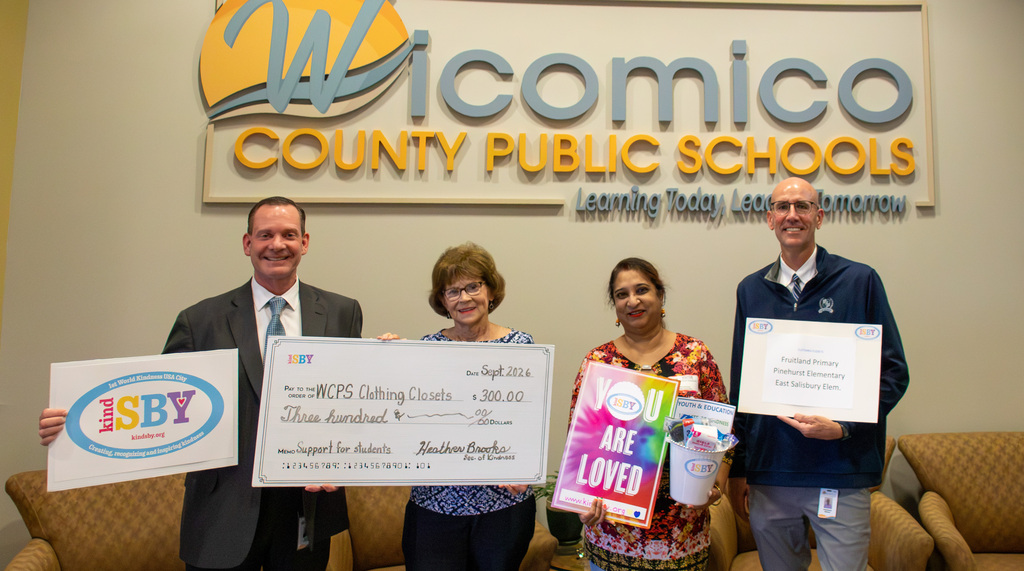 Image of #kindSBY's Grace Murdock presenting check for $300 to Superintendent Dr. Micah Stauffer and Assistant Superintendent Dr. Rick Briggs for the Clothing Closets at three elementary schools in Wicomico County