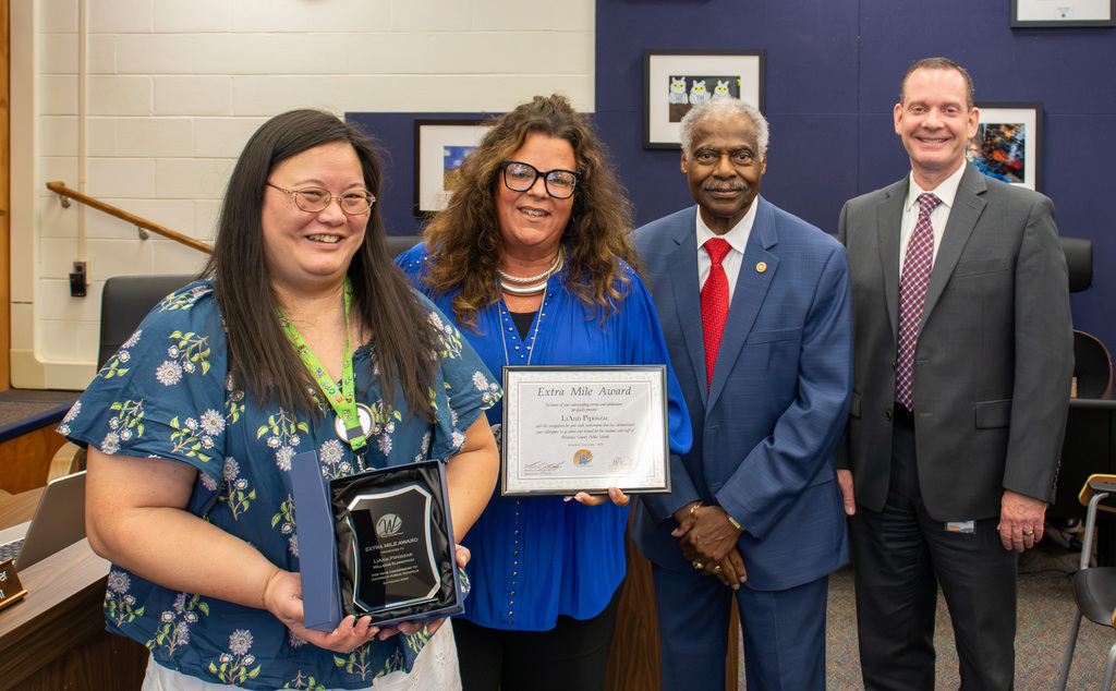Image of September Extra Mile Award recipient LiAnn Piposzar of James M. Bennett High School with Willards Elementary Principal Jennifer Rice, Board Member Allen Brown and Superintendent of Schools, Dr. Micah Stauffer