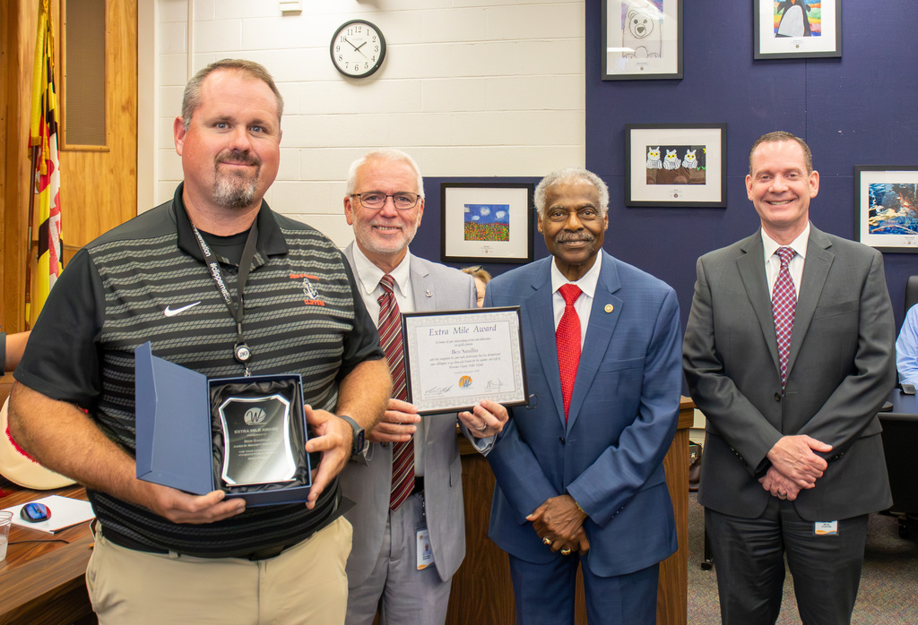Image of September Extra Mile Award recipient Ben Sandlin of James M. Bennett High School with JMB Principal Matthew Donovan, Board Member Allen Brown and Superintendent of Schools, Dr. Micah Stauffer
