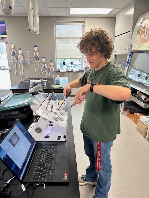 Brett trying the laparoscopic surgery trainer.