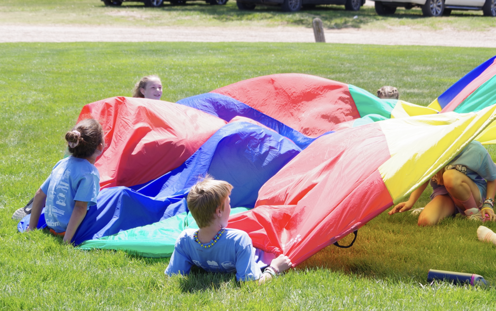 Fourth graders playing with a parachute.