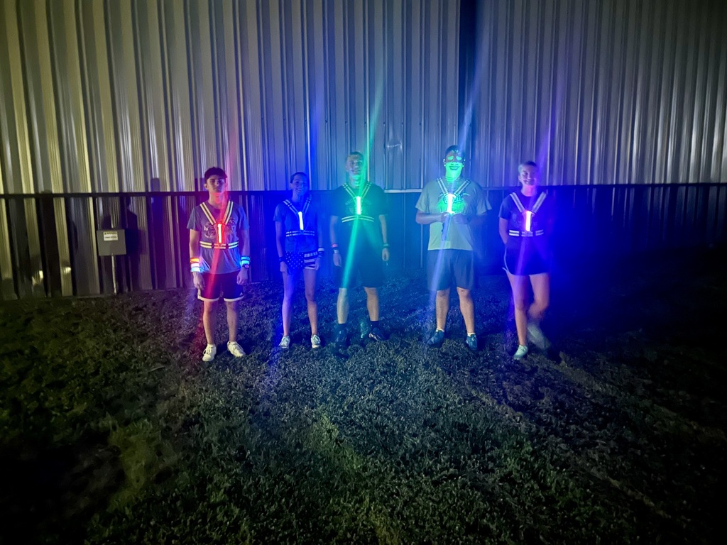 Cross Country Runners Alex K., Chloe J., Jacob J., Craig B., and Allegra J. are all glowing after their midnight run