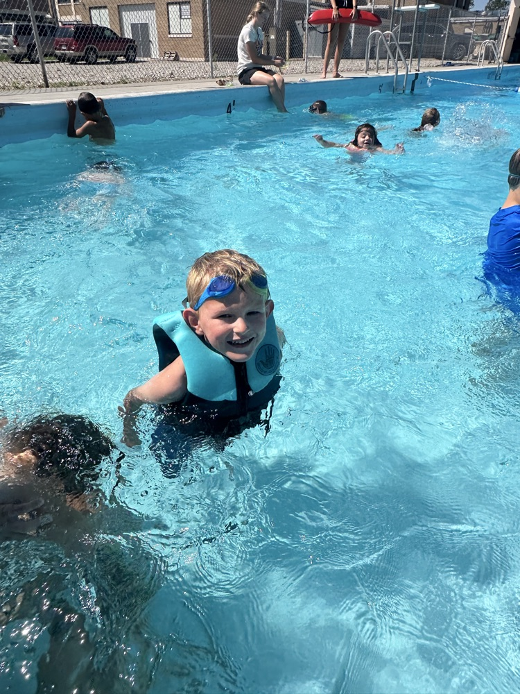 One student smiling in a pool