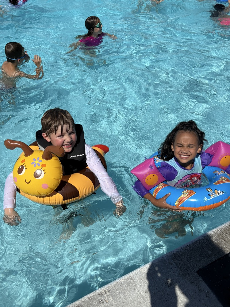 Two students with Floaties in a pool