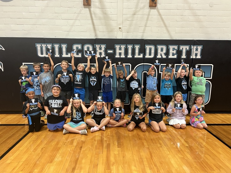 22 falcon students smiling with their falcon cards