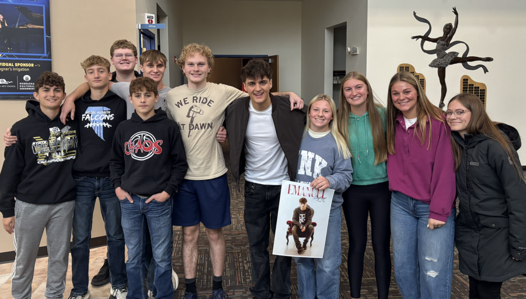 Taylor, Alex, Jadon, Kinley, Elin, Allegra, Keegan, Kaden, Stetson, Rylan posing with Emanuel after the concert