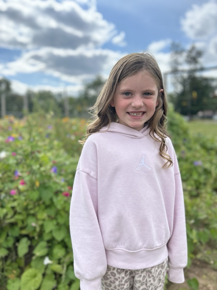 second graders pick flowers in school garden