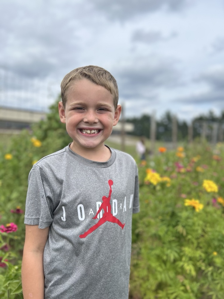 second graders pick flowers in school garden