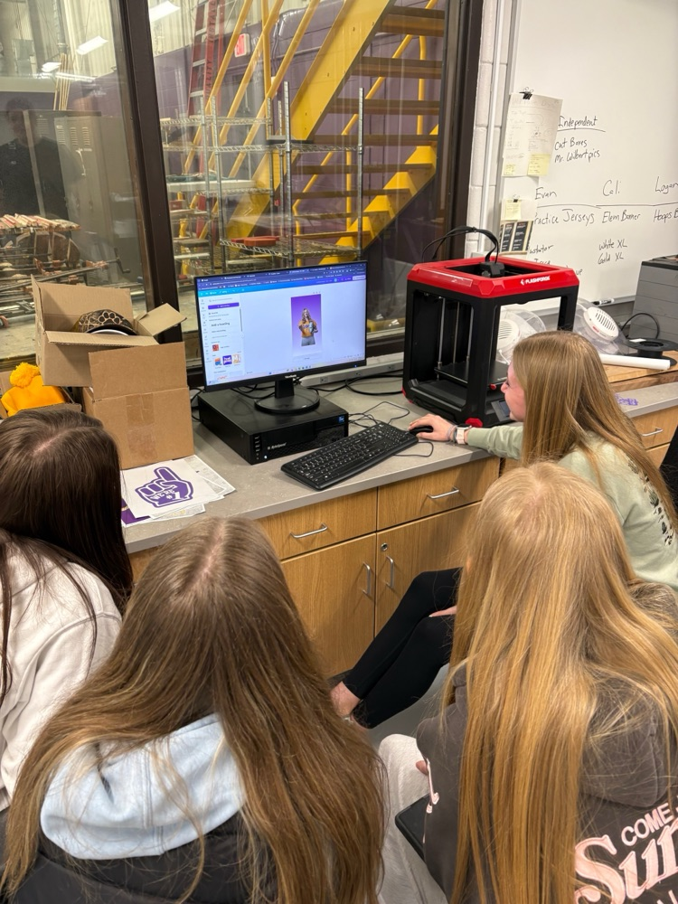 Students in the Wildcat Products class work on screen-printed shirts