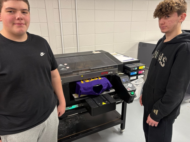 Students in the Wildcat Products class work on screen-printed shirts