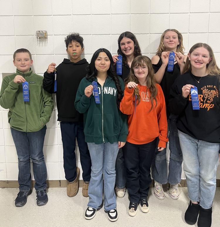 middle school forensics team holding ribbons