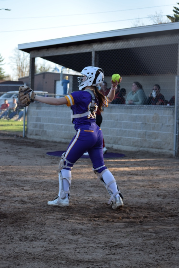 softball catcher throws ball