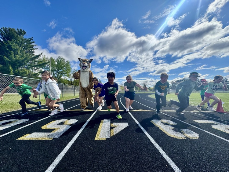 students run with the wildcat on elementary field day