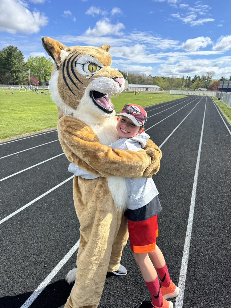 student hugs Wildcat on elementary field day