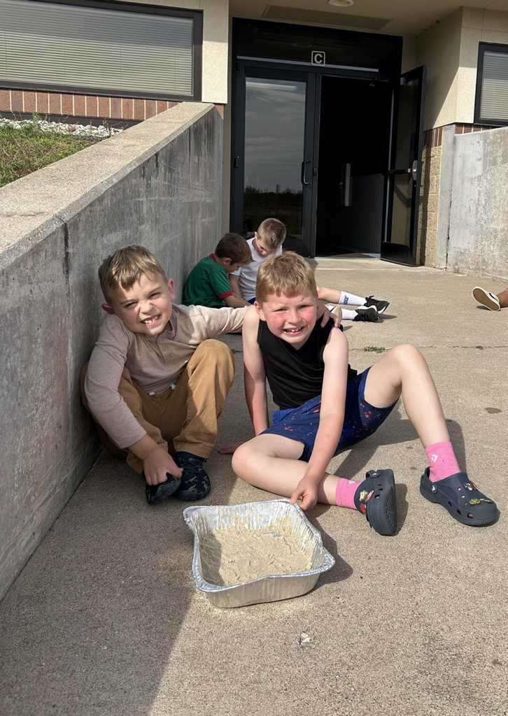 2nd graders create landscapes in wet sand