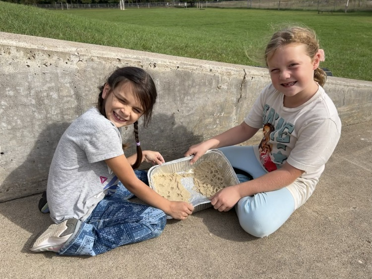 2nd graders create landscapes in wet sand