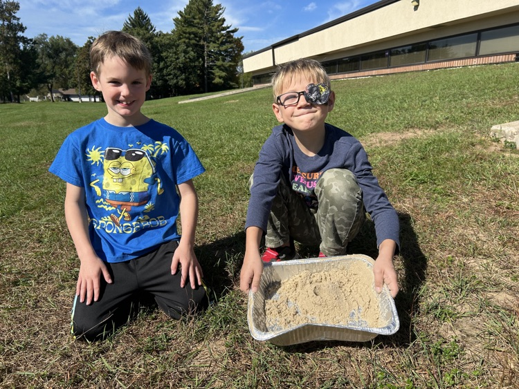 2nd graders create landscapes in wet sand