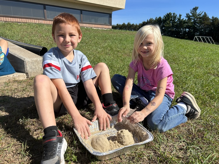 2nd graders create landscapes in wet sand