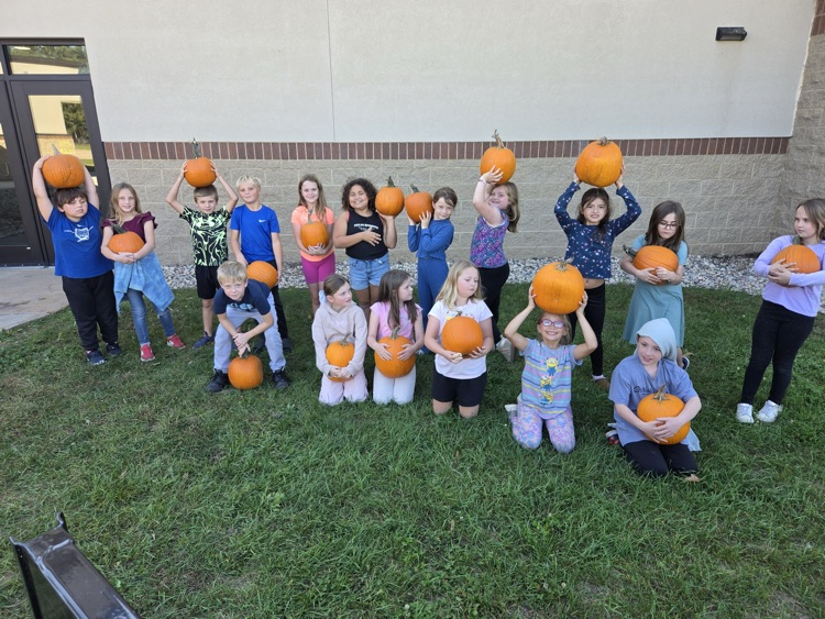 group of WRE students holding pumpkins