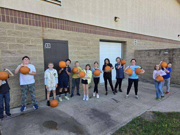 group of WRE students holding pumpkins