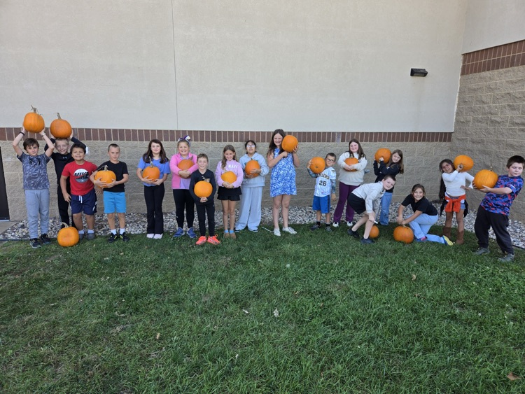 group of WRE students holding pumpkins